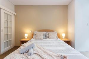 a bedroom with a large bed with two lamps at Perth Central CBD convenience! in Perth