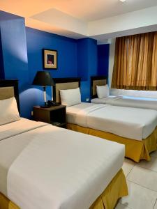 Postel nebo postele na pokoji v ubytování WJV Premium Hotel