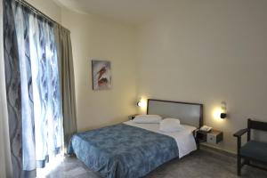 Posteľ alebo postele v izbe v ubytovaní Rodon Hotel
