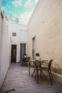 a patio with a wooden table and chairs at Sami Twin Suite in Lecce