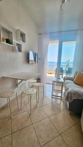 a living room with a couch and a table and chairs at Apartmani Vinka in Pisak