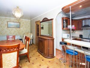 a kitchen and dining room with a table and chairs at ApartLux Savelovskaya Suite in Moscow