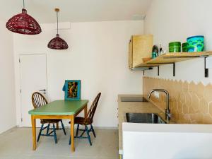 a kitchen with a table and chairs and a sink at Studio Indigo in Aljezur +20 photos