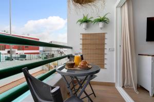a table with food on it on a balcony at Pippa’s House 2 in San Agustin
