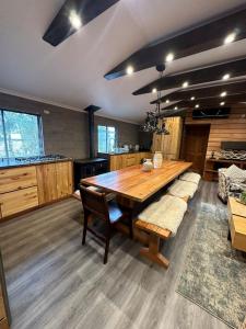 a large kitchen with a wooden table and chairs at Leñador in Antuco