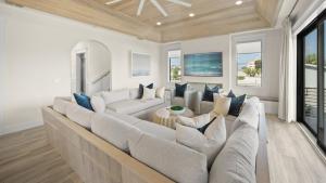 a large living room with a large couch at Salty Sunrise in Clearwater Beach
