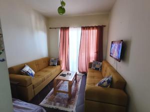 a living room with a couch and a table at Porto Matrouh Chalet شاليه بورتو مطروح in Marsa Matruh