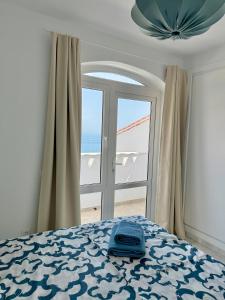 a bedroom with a bed and a window with the ocean at Villla Clementina in Nerja