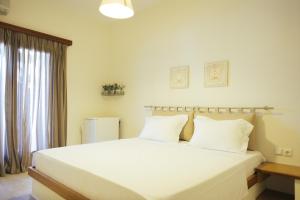 Postel nebo postele na pokoji v ubytování Faros Hotel