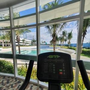 a room with a view of a swimming pool and a clock at K Place Staycation at Azure North in San Fernando