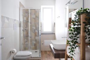 a bathroom with a shower and a toilet and a sink at Asia cozy apartment in Milazzo