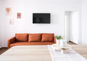 a living room with a couch and a table at Asia cozy apartment in Milazzo
