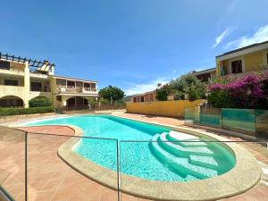 a swimming pool in front of a house at Casa BiBa in Villasimius