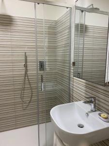 a bathroom with a sink and a glass shower at Hotel Raffaelli Villa Angela in Forte dei Marmi