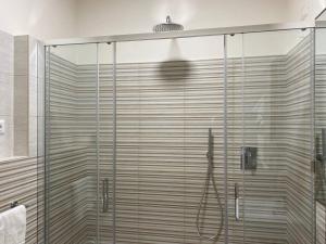a shower with a glass door in a bathroom at Hotel Raffaelli Villa Angela in Forte dei Marmi