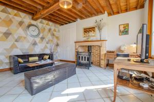 a living room with a couch and a fireplace at Les grand' vignes in Laines-aux-Bois