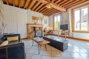 a living room with a couch and a fireplace at Les grand' vignes in Laines-aux-Bois