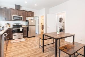 a kitchen with a table and a kitchen with stainless steel appliances at Walkable Apt Next to Restaurants, Bars, and Shops! in Portland +35 photos