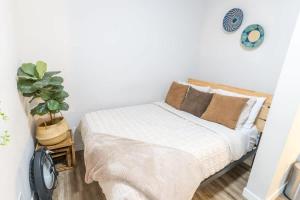a bedroom with a bed and a potted plant at Walkable Apt Next to Restaurants, Bars, and Shops! in Portland
