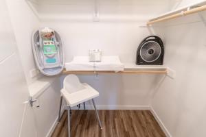 a small white room with a desk and a fan at Walkable Apt Next to Restaurants, Bars, and Shops! in Portland