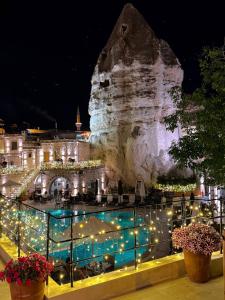 a view of a resort at night with lights at Göreme Cave Suites in Göreme
