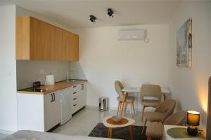 a kitchen with a table and chairs in a room at The River Studio Beli in Podgorica