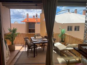 a balcony with a table and chairs and an umbrella at Casa Reina in Playa Jandia