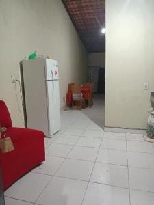 a kitchen with a white floor and a refrigerator at Hospedaria lençóis em santo amaro MA in Santo Amaro