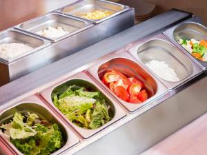 a refrigerator with six trays of tomatoes and lettuce at APA Hotel Akihabara Ekimae in Tokyo