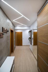 an office corridor with wooden doors and wooden floors at Central Park Apartment in Veliko Tŭrnovo