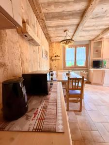 a kitchen with a table and a dining room at Casa Clus Bormio apartments 3 in Valdisotto