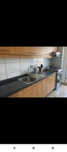 a kitchen with a sink and a stove at Bellavista in Viña del Mar