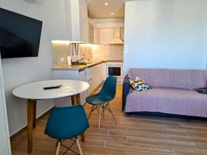a living room with a couch and a table and chairs at Athens Pearl in Athens