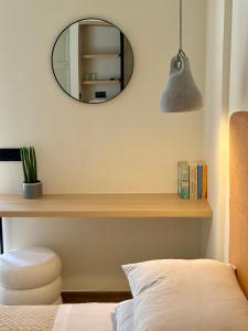 a bedroom with a mirror and a bed and a chair at Yria Hotel in Zakynthos Town