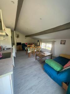 a living room with a blue couch and a table at appartement 2 bord de mer in Farinole