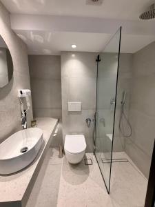 a bathroom with a sink and a toilet and a shower at Yria Hotel in Zakynthos Town