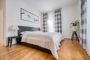 a bedroom with a bed and a wooden floor at Apartment with garden in Prague 6 in Prague