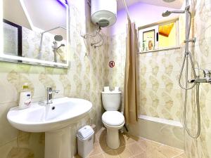 a bathroom with a sink and a toilet and a shower at GenAl Apartaments in Tirana