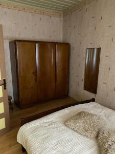 a bedroom with a bed with wooden headboards at Regina apartment in Ventspils