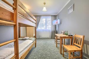 a bedroom with a bunk bed and a desk at Rezydencja Karnat in Karpacz