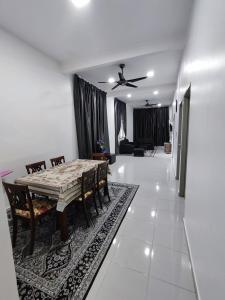 a dining table and chairs in a living room at Homestay Temerloh Near Hospital 4Bedroom 3Air-cond Free Wi-Fi Netflix in Temerloh