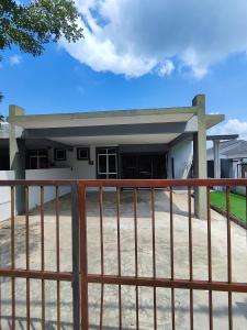 a building with a gate in front of it at Homestay Temerloh Near Hospital 4Bedroom 3Air-cond Free Wi-Fi Netflix in Temerloh +23 photos