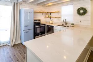 a kitchen with a white counter top and a refrigerator at Stylish 2BR n Old Town Greenwood in Greenwood