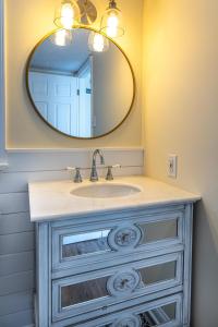 a bathroom with a sink and a mirror at Stylish 2BR n Old Town Greenwood in Greenwood
