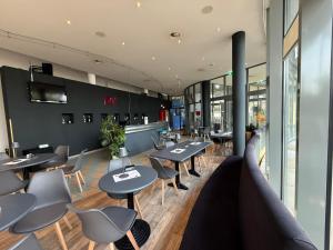 a restaurant with tables and chairs in a building at Savoy Hotel Bad Mergentheim in Bad Mergentheim