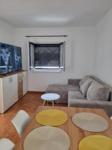 a living room with a couch and a table at Kuća za obiteljski odmor Ulrich in Lukovo
