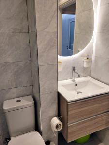 a bathroom with a toilet and a sink and a mirror at Athens Pearl in Athens +33 photos