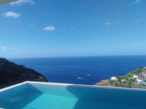 a view of the ocean from a swimming pool at Villa Gia in Calheta +34 photos