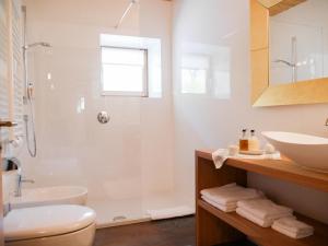 un bagno bianco con doccia e lavandino di Mitterstiller ad Auna di Sotto
