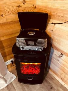a stove with a laptop on top of it at Country Cottage & Spa in Labalme +40 photos